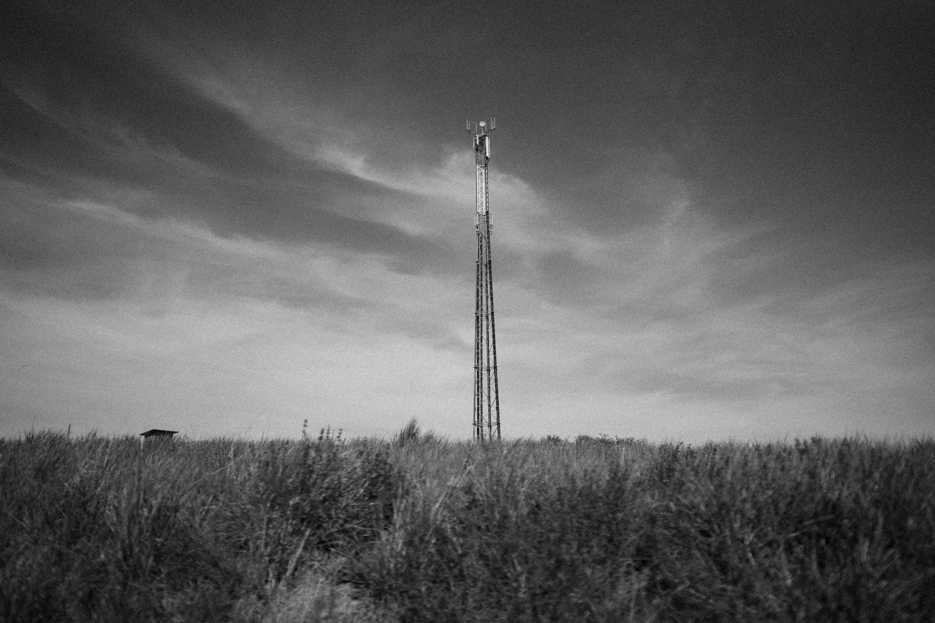 grayscale photo of electric tower